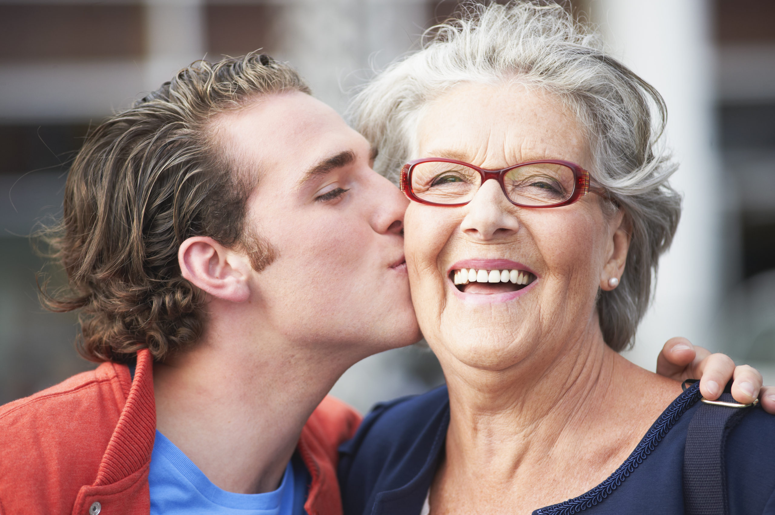 Young,Man,Kissing,Smiling,Grandmother